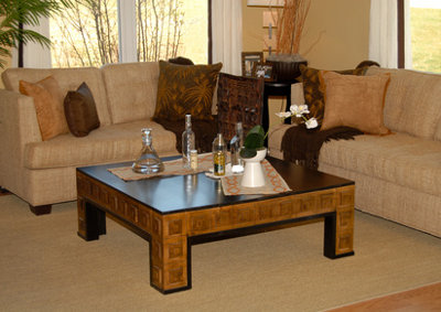 Living room setting with couch and coffee table done in earth tones